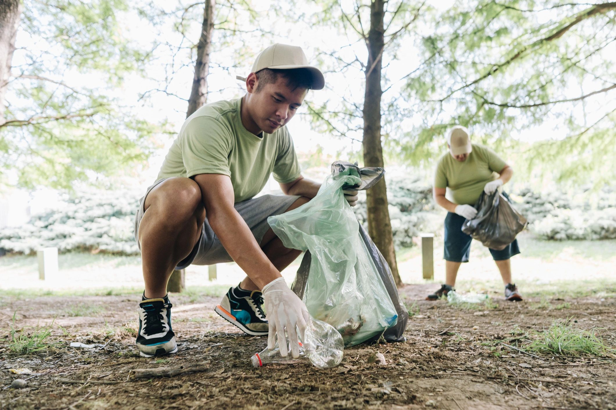 Volunteer collecting debris outdoors